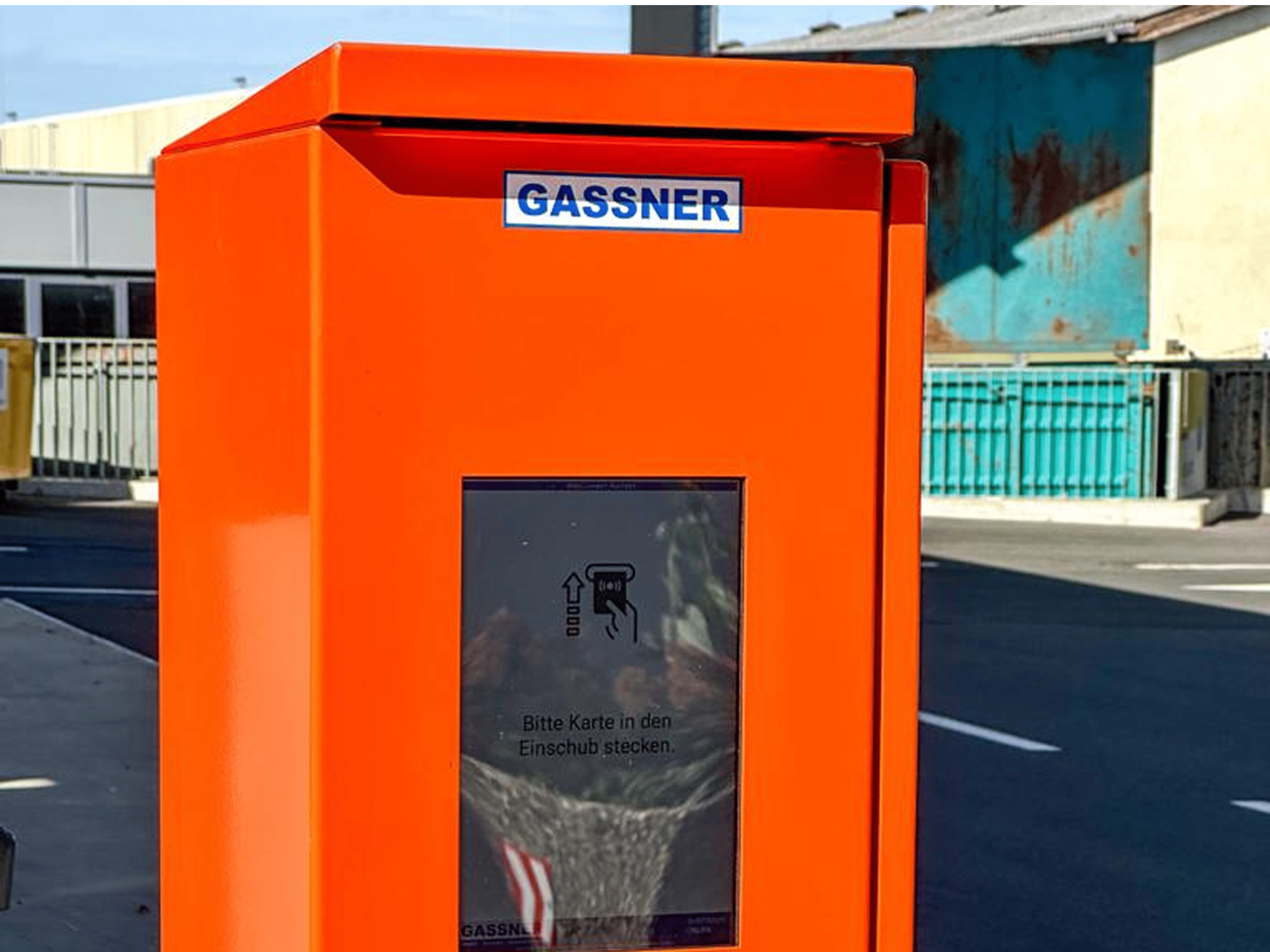 Close view of a self-service terminal with touchscreen and RFID or payment area.